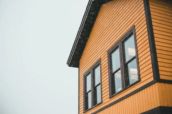 wooden siding with green wooden window