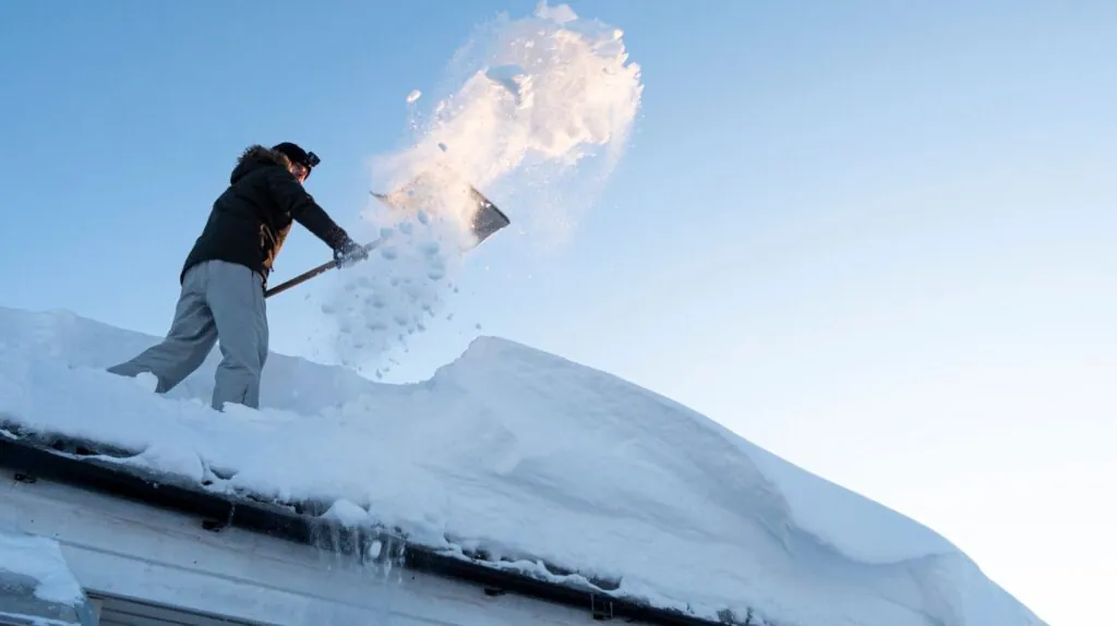 a man prepairing the roof for replacement